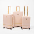 Set de 3 valises rigides rose poudré Titou avec finitions dorées et poignées télescopiques